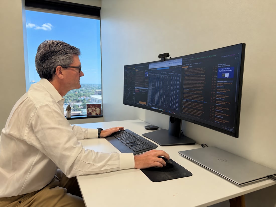 RCM co-founder David Roosevelt reviewing portfolio data at his desk.